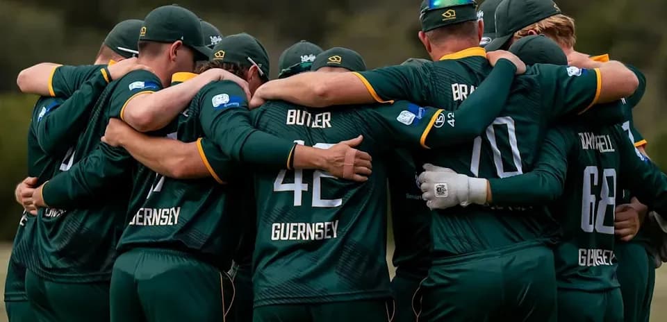 Cricket team huddled together in unity