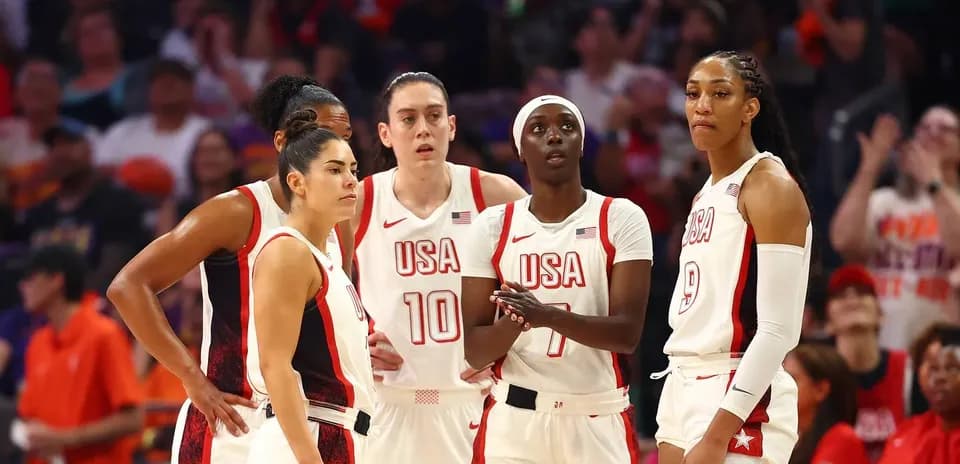 USA women's basketball team strategizing during game