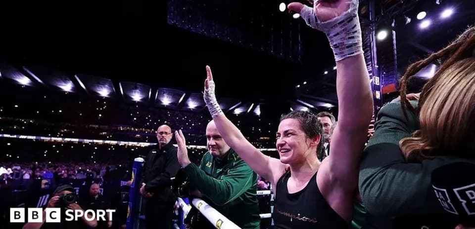 Boxer celebrating victory with raised hands in arena