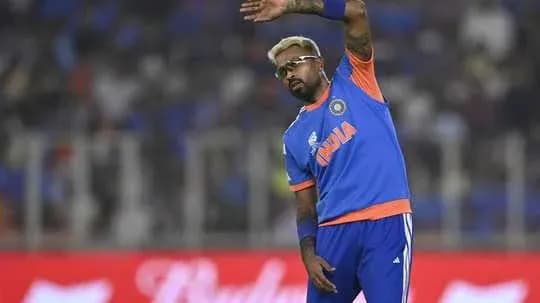 Cricketer waving to crowd during match
