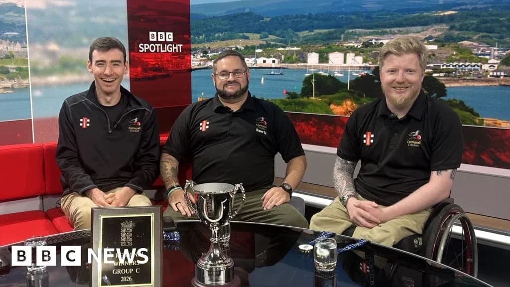 Three men celebrating with trophy on studio set