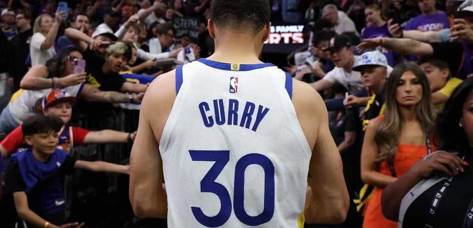 Player wearing jersey surrounded by cheering fans