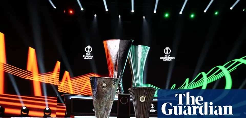 UEFA trophies displayed on stage with lighting effects