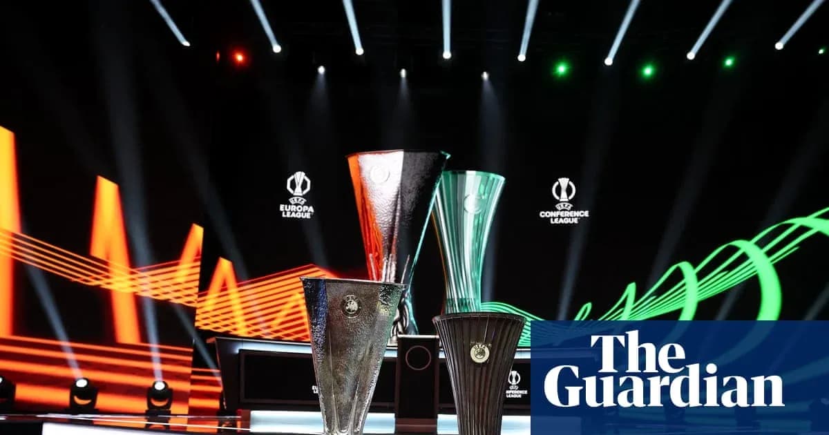 UEFA trophies displayed on stage with lighting effects