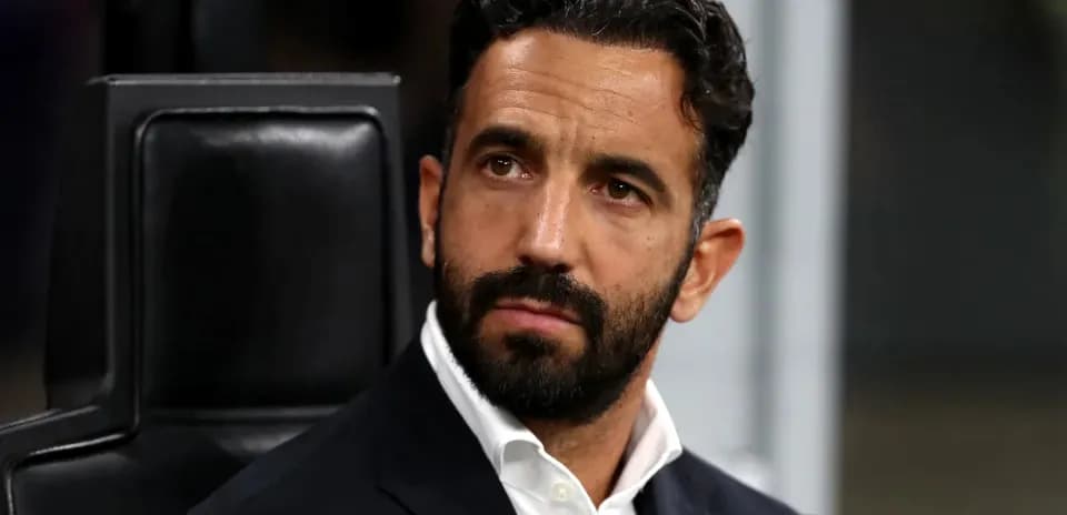 Coach seated on bench during match