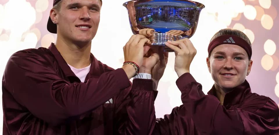 Players celebrating victory with trophy after match