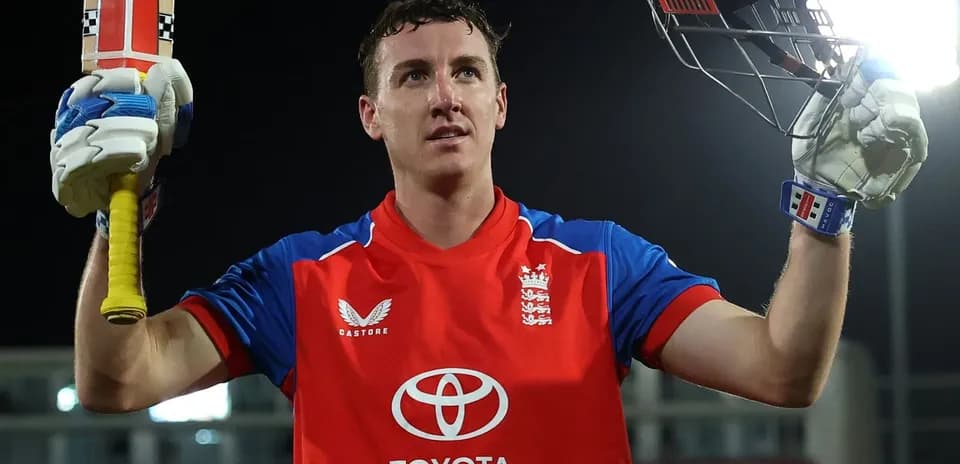 Batsman celebrating with raised bat after scoring