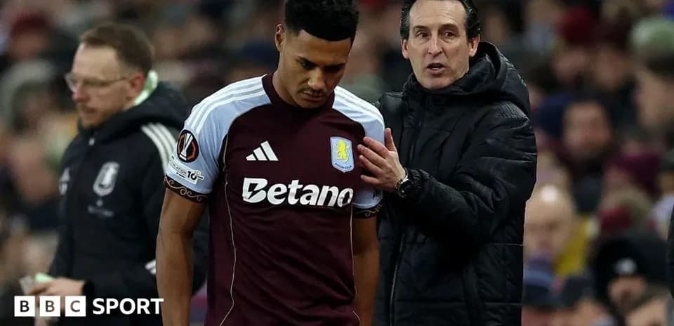 Aston Villa player speaking with manager during match