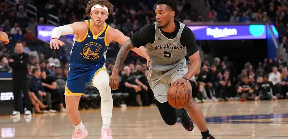 Player dribbling basketball with defender nearby