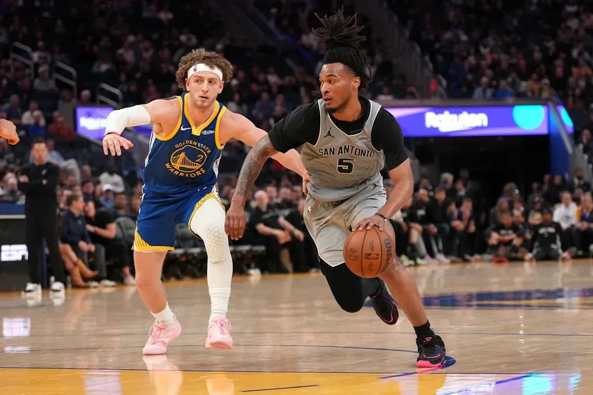 Player dribbling basketball with defender nearby