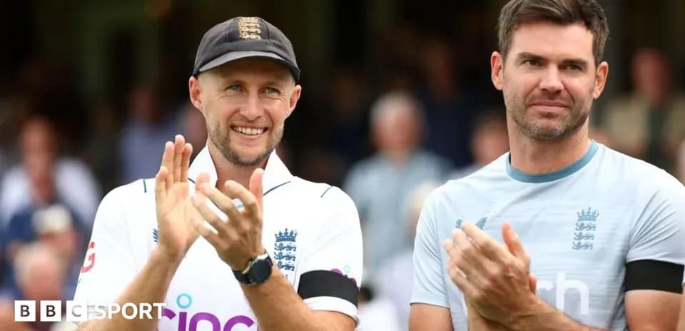 Two cricketers applauding on the field