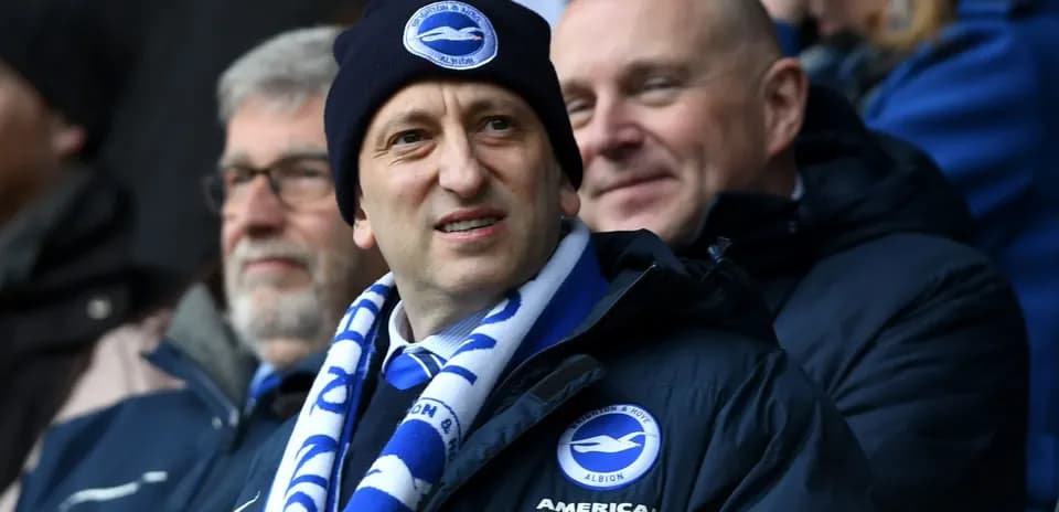 Man in Brighton scarf and hat at stadium