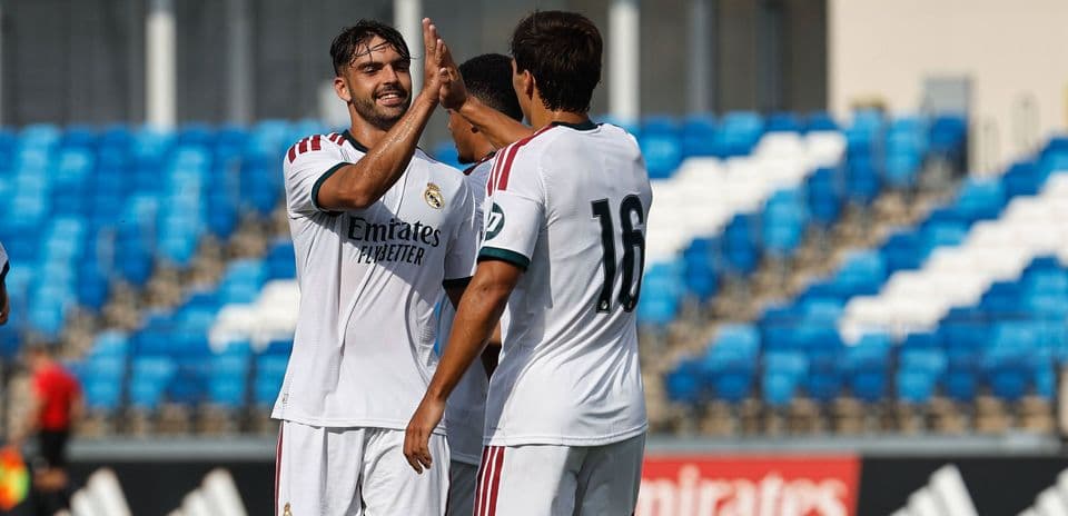 Real Madrid players celebrating a goal on pitch
