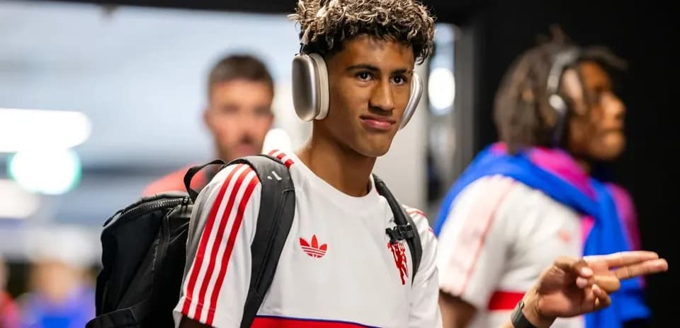 Player wearing headphones entering locker room