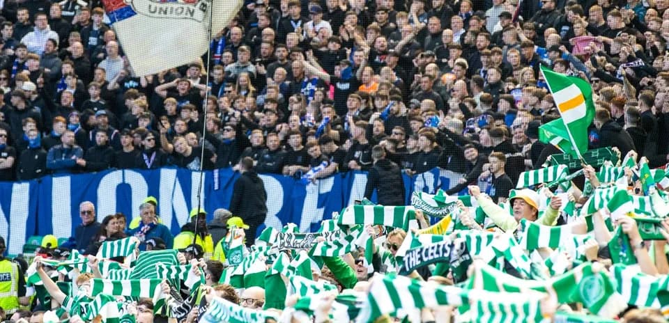 Fans waving scarves in stadium during match
