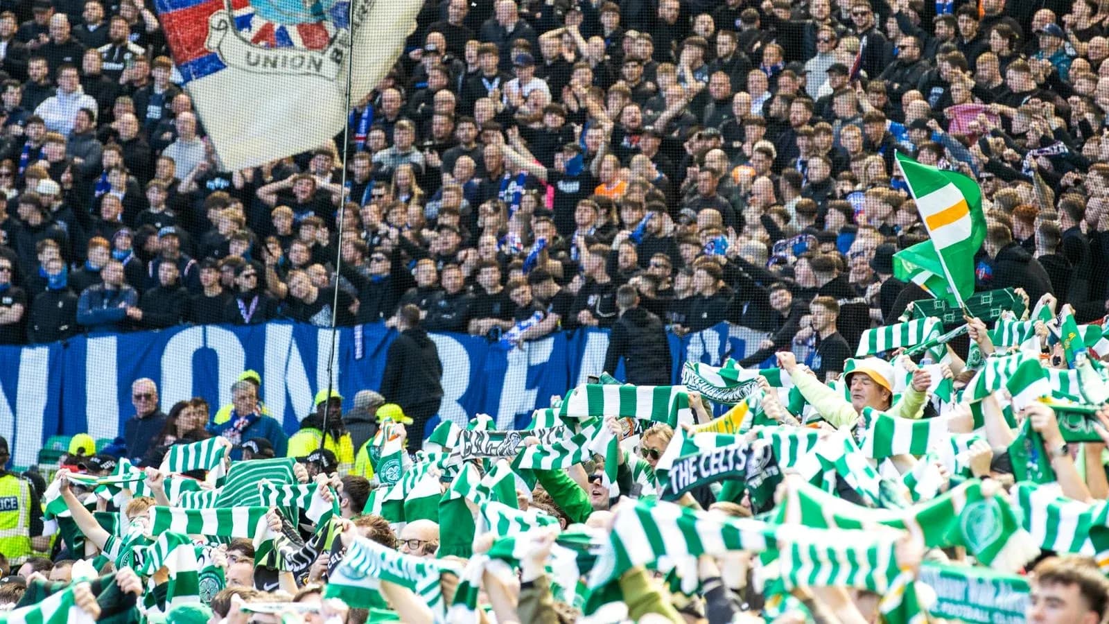 Fans waving scarves in stadium during match