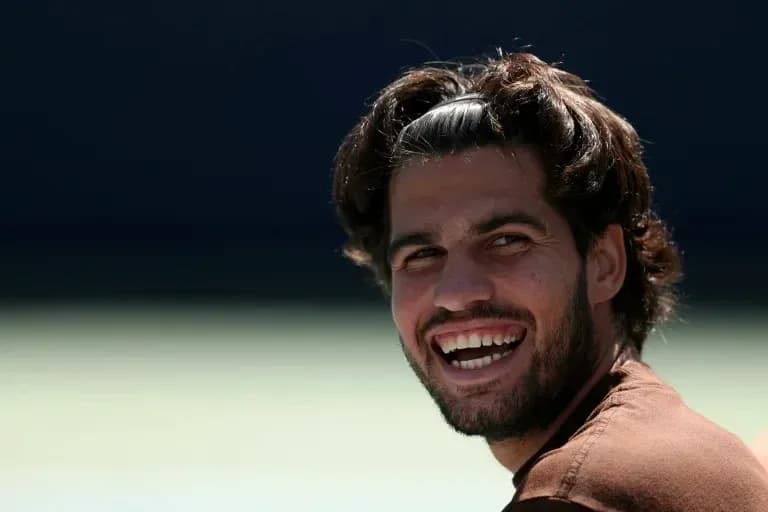 Tennis player smiling during training session