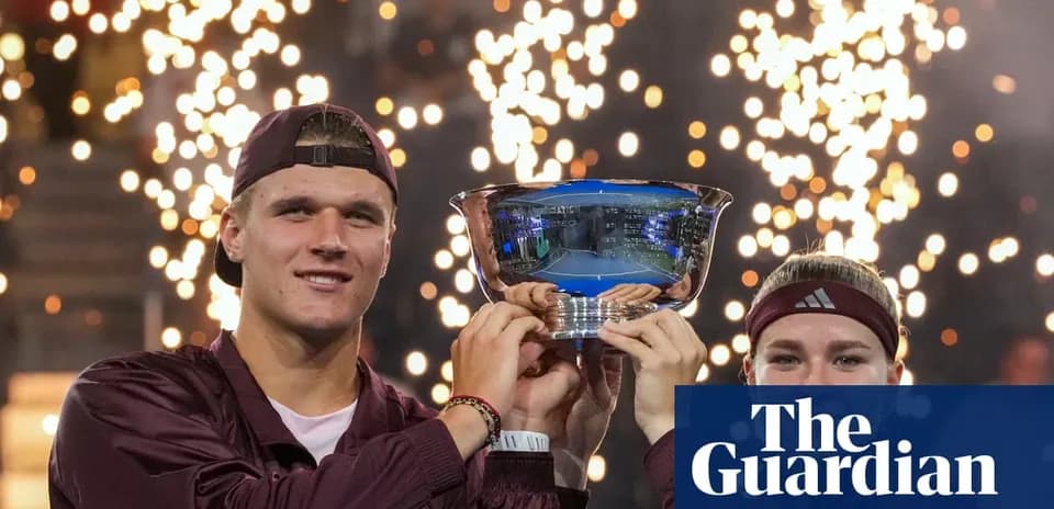 Two players celebrating victory with trophy and fireworks