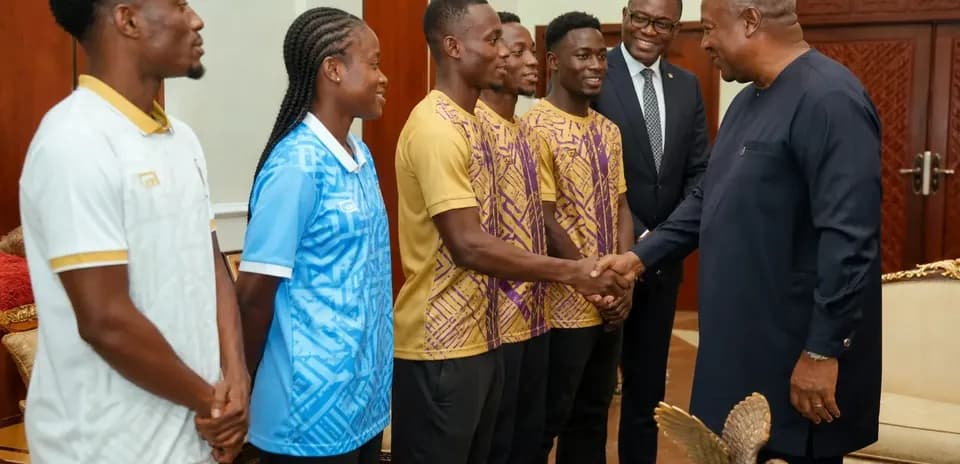 Athletes meeting with a dignitary in an office