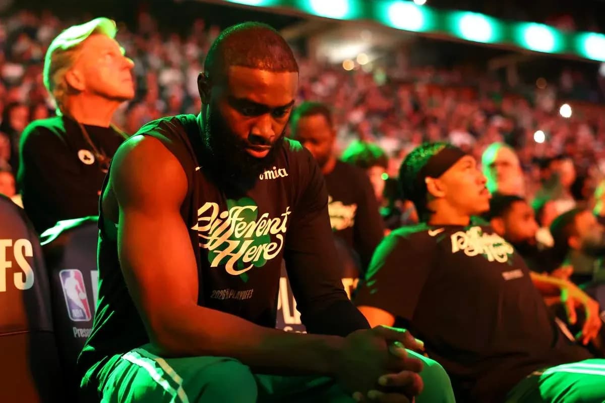 Players sitting on bench during game introduction ceremony