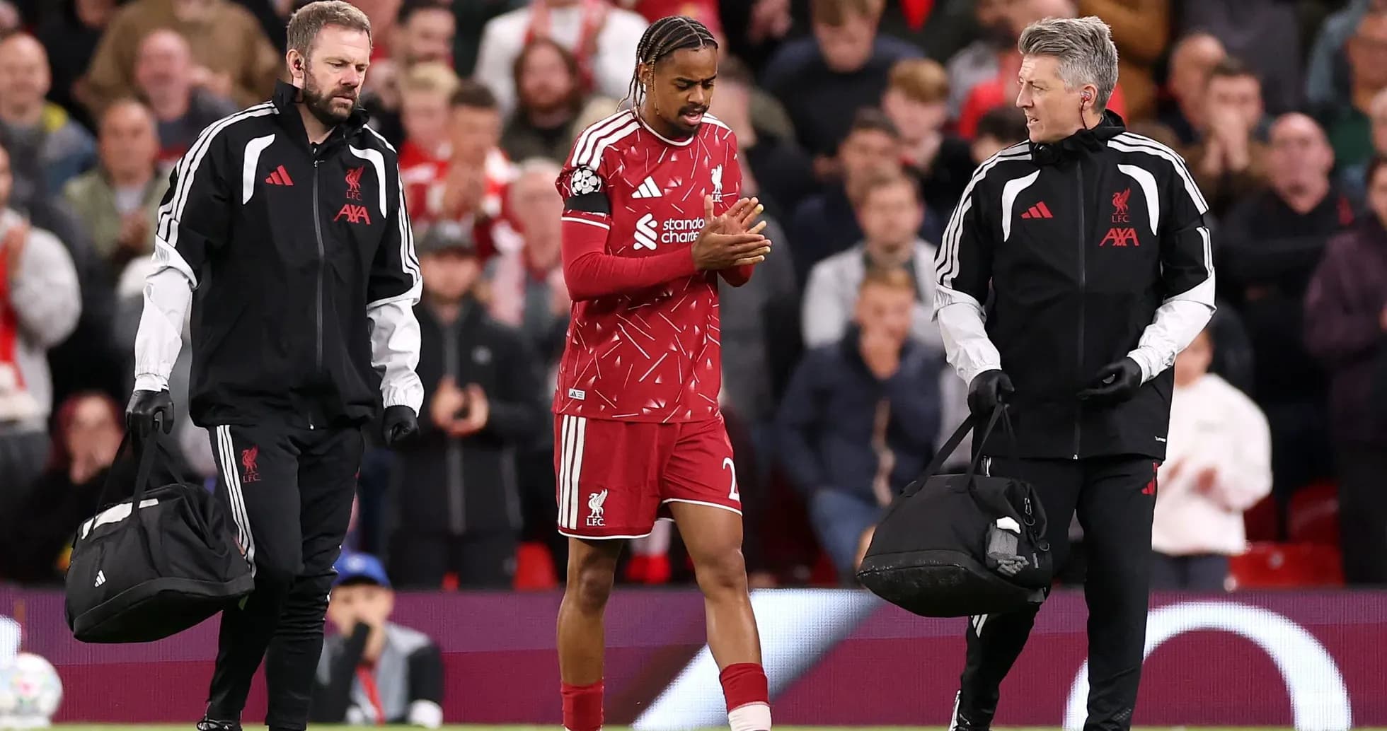 Player being assisted off the field by staff