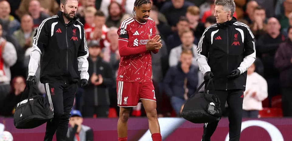 Player being assisted off the field by staff