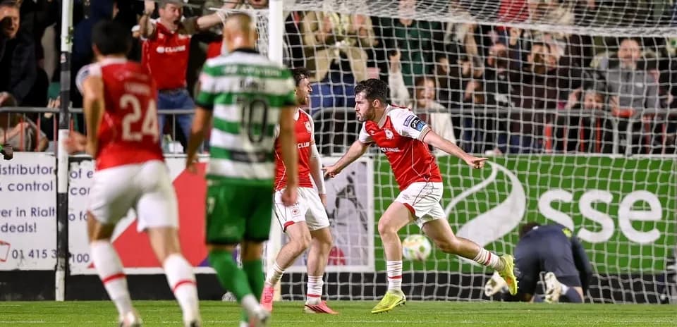 Player celebrating a goal with teammates in match
