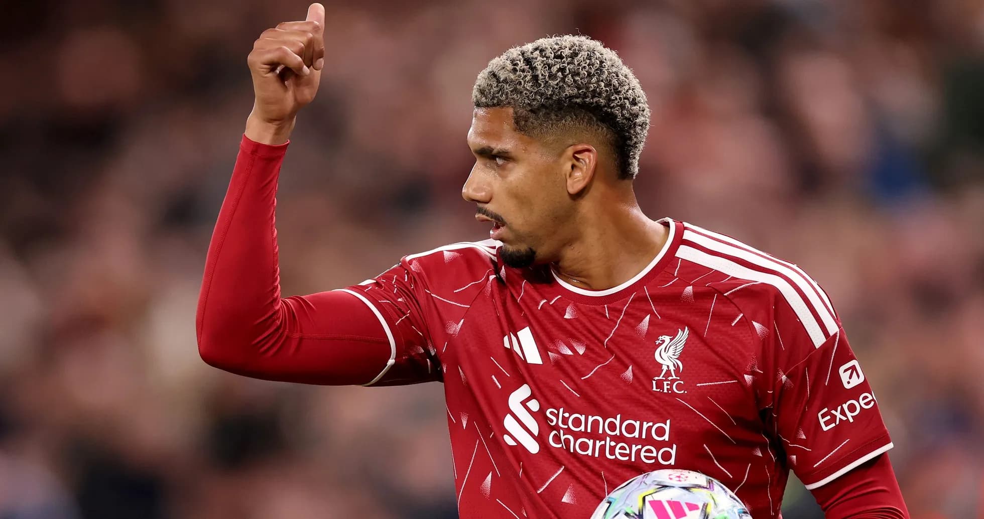 Player in Liverpool kit signaling during match