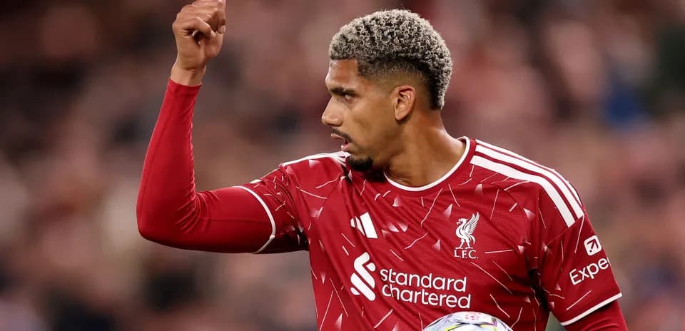 Player in Liverpool kit signaling during match