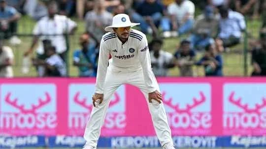 Cricketer fielding during a match with spectators in background