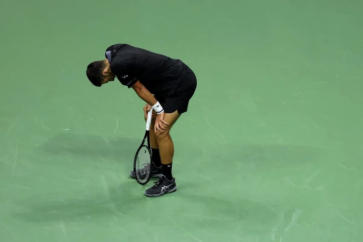 Player bending over on tennis court after match