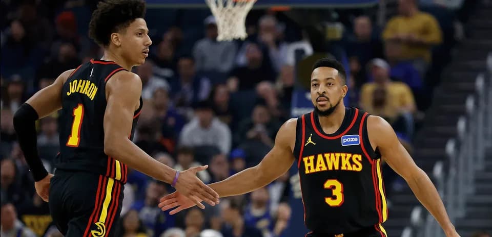 Two Hawks players celebrating during a game