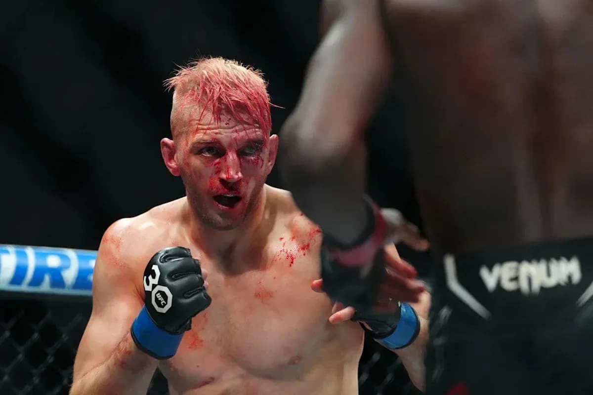 Fighter with blood on face during MMA match