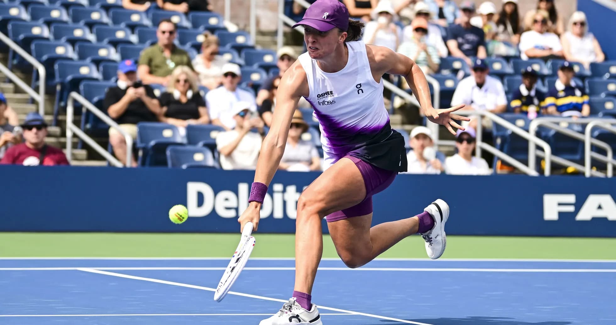 Player reaching for a tennis ball during match