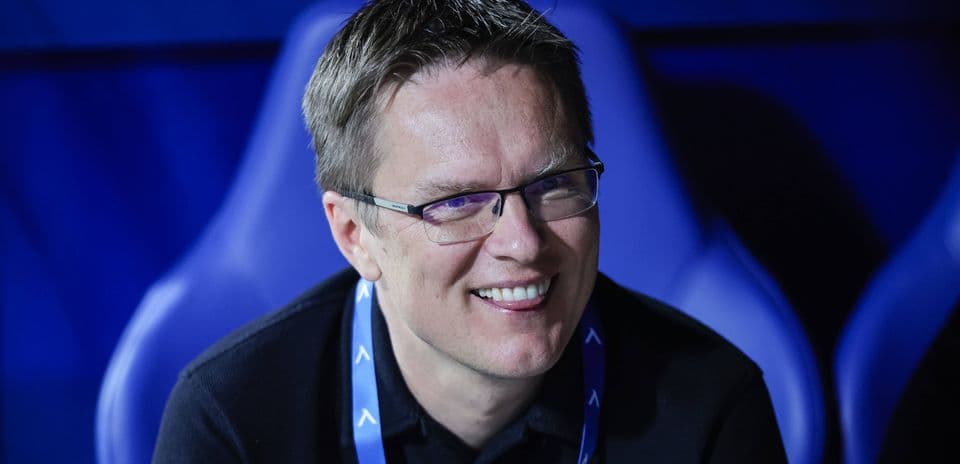 Man smiling in a sports venue seat
