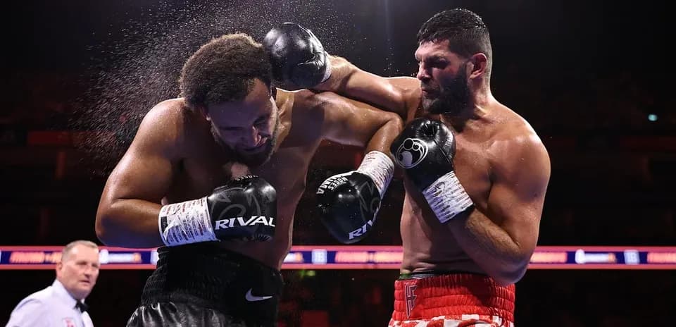 Boxers exchanging punches in the ring during match