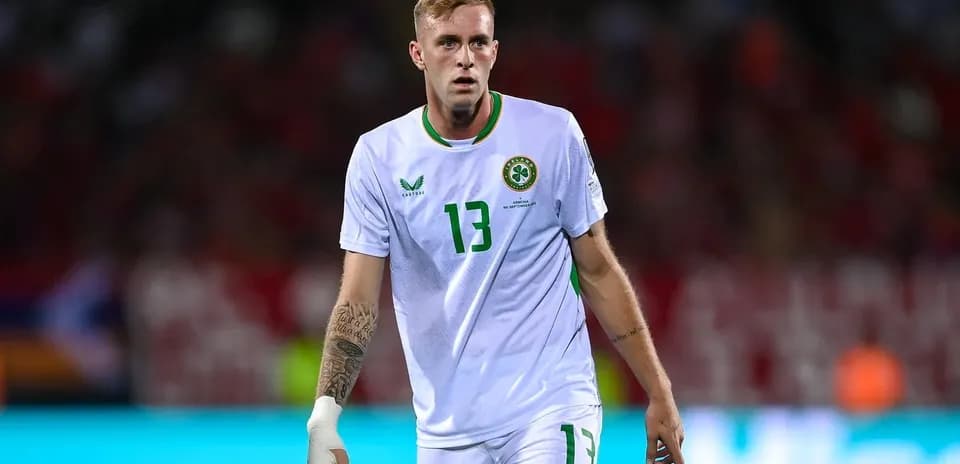 Player wearing white jersey with number 13 on pitch