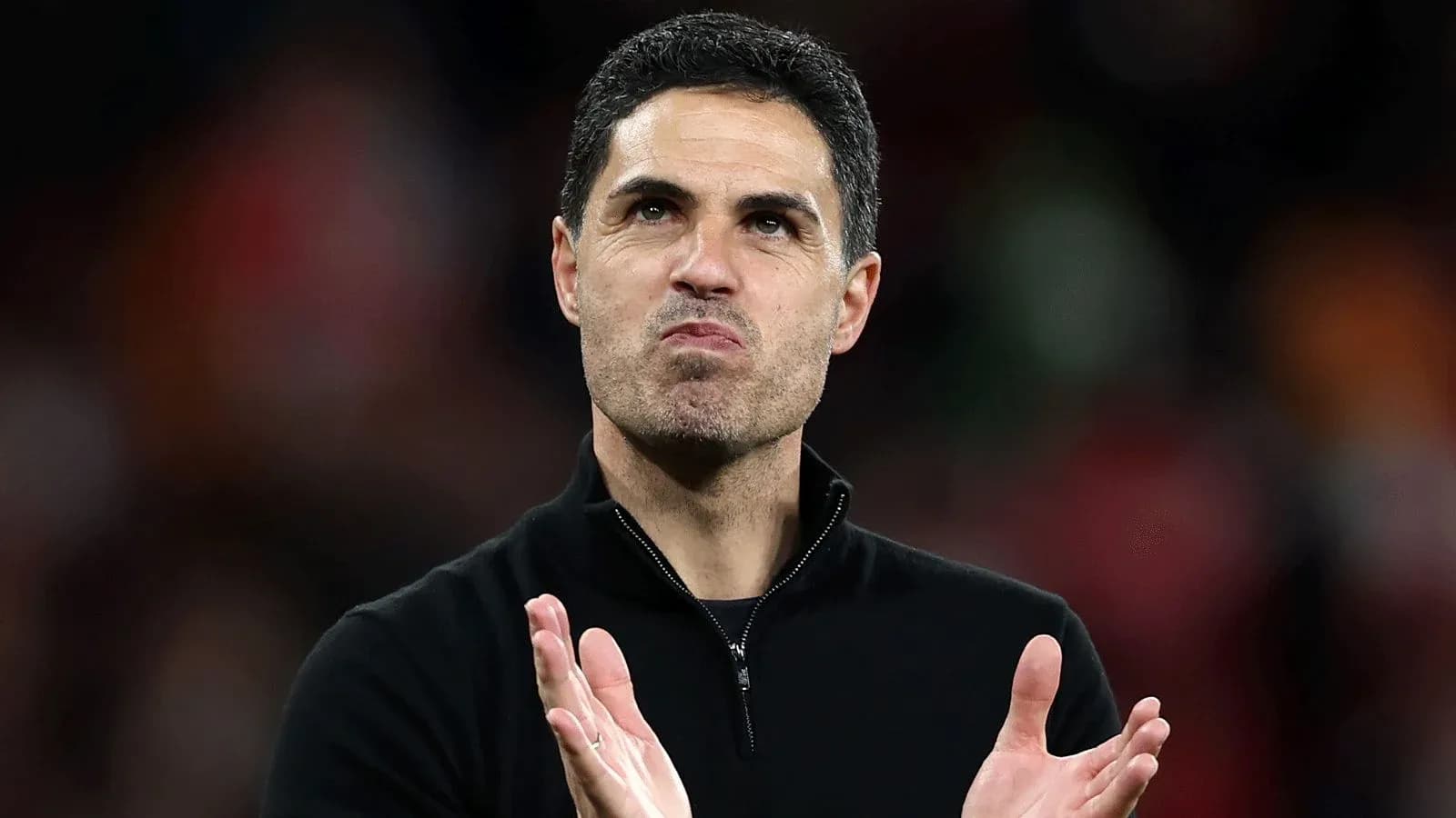 Coach applauding during post-match celebrations