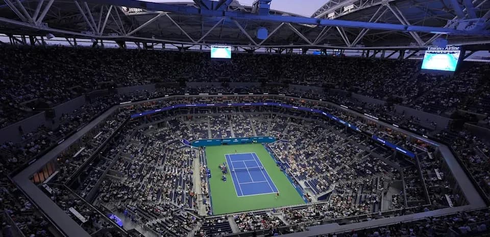 Empty tennis stadium during evening match