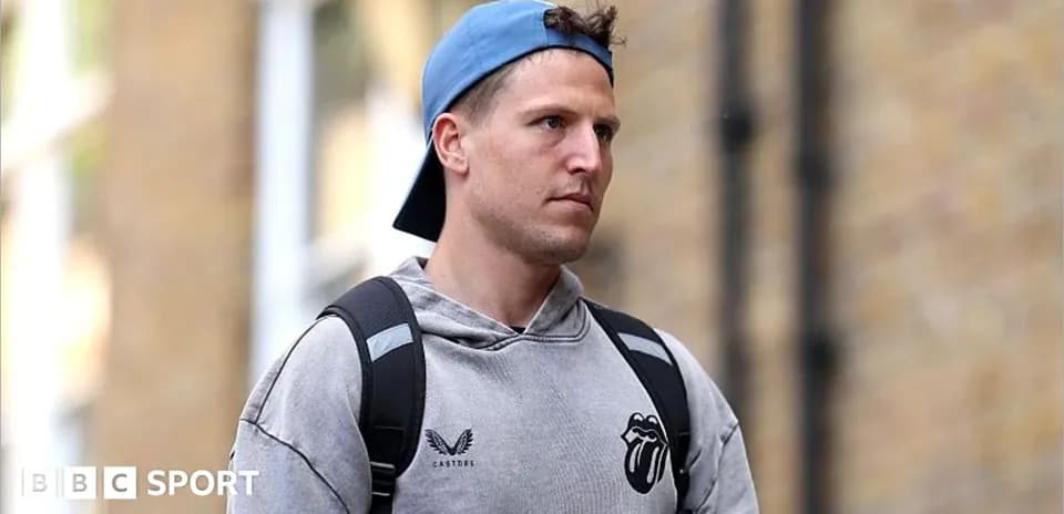 Man walking with backpack and cap in urban setting
