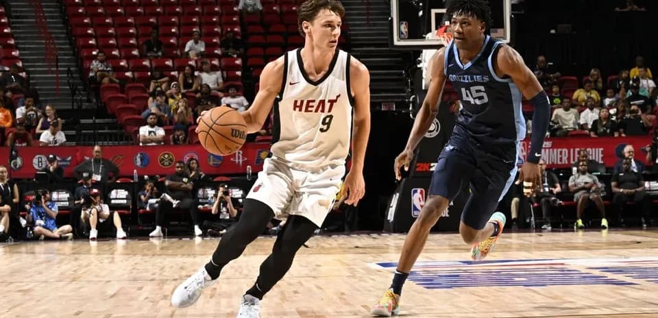 Player from Miami Heat dribbling basketball against defender