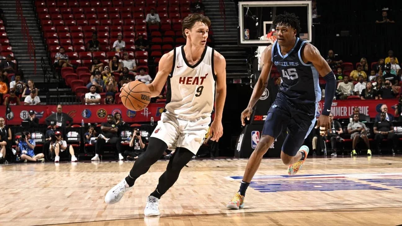 Player from Miami Heat dribbling basketball against defender