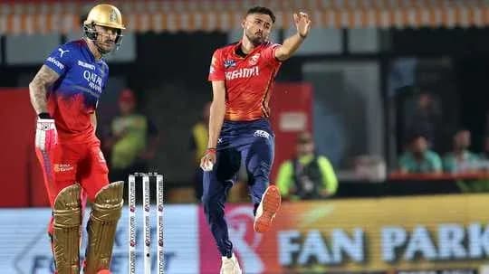 Bowler delivering ball while batsman prepares to bat Bowler delivering ball while batsman prepares to bat
