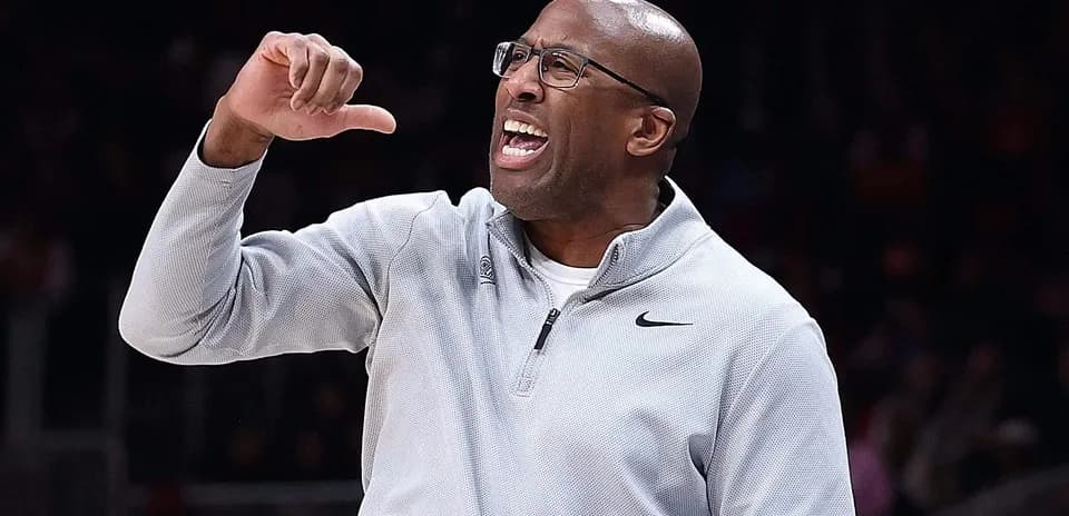Coach gesturing and directing players during game