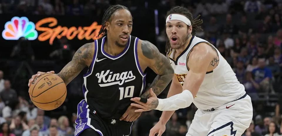 Player dribbling basketball while being closely guarded