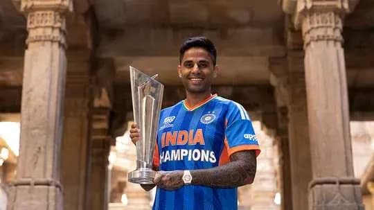 Player holding trophy in India champions jersey