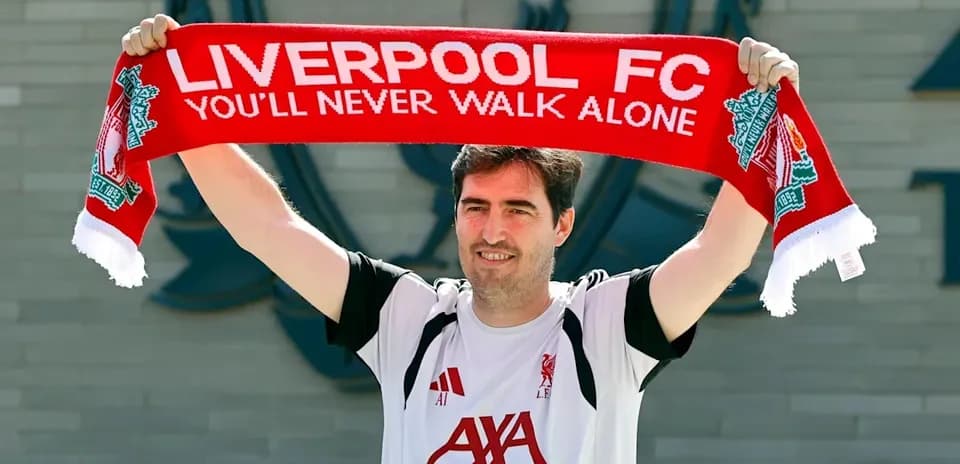 Person holding Liverpool FC scarf at club announcement