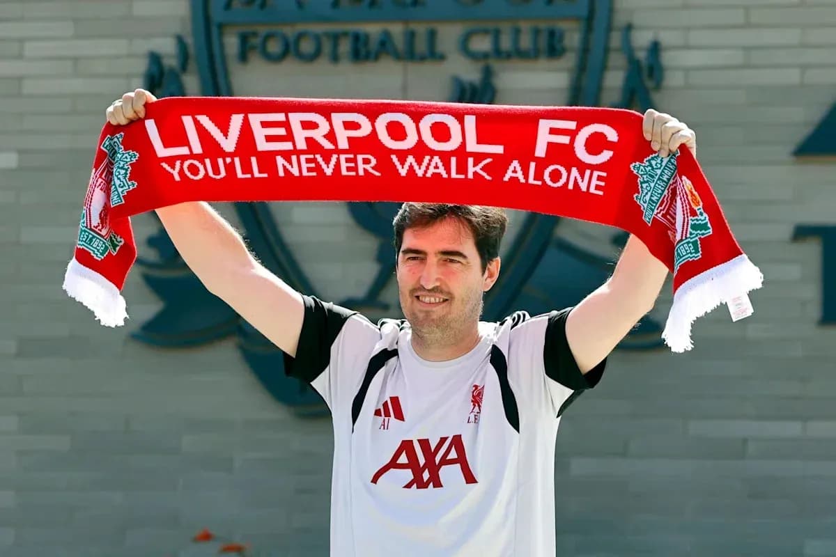 Person holding Liverpool FC scarf at club announcement