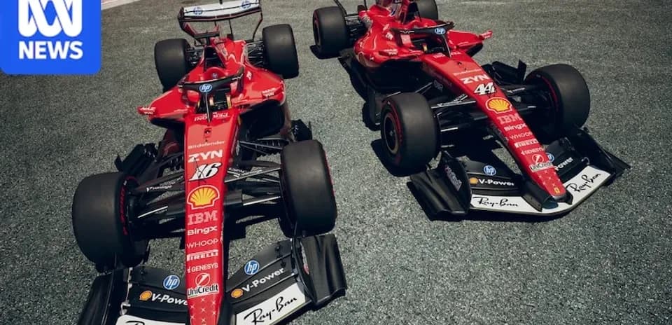 Two Ferrari Formula 1 cars parked on track