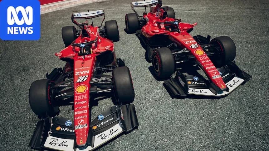Two Ferrari Formula 1 cars parked on track